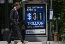 Fed to buy as much government debt as needed to aid economy