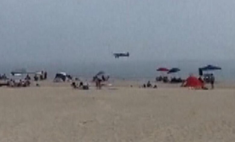 A small plane towing a banner lands in the ocean off a crowded new hampshire beach pilot unhurt