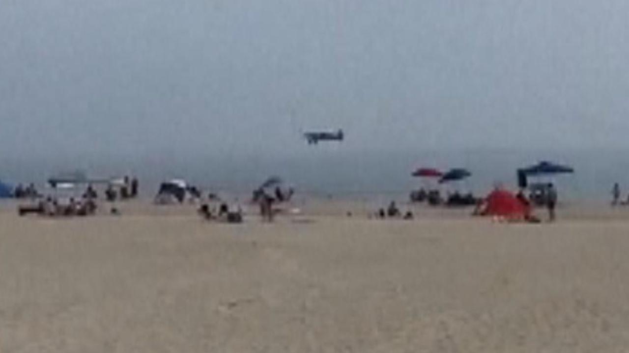 A small plane towing a banner lands in the ocean off a crowded new hampshire beach pilot unhurt