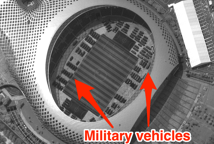 Chinese military vehicles stashed across hong kong border in soccer stadium satellite images appear to show