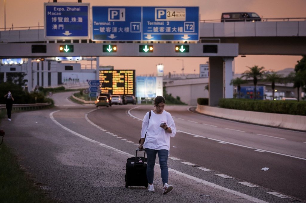 Kong protesters departure flights protest placards terminals cancels disrupt demonstration kwan Flights resuming at hong kong airport after protest chaos